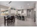 Kitchen featuring white cabinets, granite countertops, stainless steel appliances, and a dining table at 19011 E Carriage Way, Queen Creek, AZ 85142
