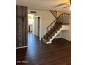 Inviting living room with wood floors and staircase leading upstairs at 4601 N 102Nd Ave # 1100, Phoenix, AZ 85037