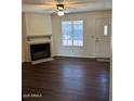 Cozy living room featuring a fireplace, ceiling fan, and natural light at 4601 N 102Nd Ave # 1100, Phoenix, AZ 85037
