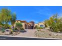 Charming home exterior featuring desert landscaping and a circular entryway at 12942 E Corrine Dr, Scottsdale, AZ 85259