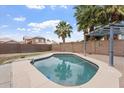 Beautiful backyard featuring a sparkling in-ground pool, a lush patio, and privacy fencing at 1520 E Flint St, Chandler, AZ 85225