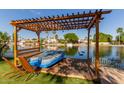 Beautiful waterfront property featuring a private dock with seating and tranquil views at 3109 N Meadow Dr, Avondale, AZ 85392