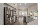 Modern kitchen featuring stainless steel appliances, white cabinets, and a breakfast nook with backyard views at 3109 N Meadow Dr, Avondale, AZ 85392