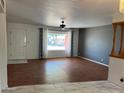 This living room features laminate flooring, a front door and a picture window at 6258 E Duncan St, Mesa, AZ 85205