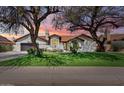 Charming single story home with a beautiful front lawn and mature trees at 7624 E Larkspur Dr, Scottsdale, AZ 85260