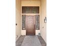 Close-up of the beautifully designed bronze front door with decorative metalwork and sidelights at , Gilbert, AZ 85233