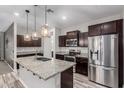 Beautiful kitchen featuring stainless steel appliances, a large island, and wood flooring at 10363 W Rosewood Ln, Peoria, AZ 85383