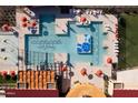 Overhead view showcasing the community pool, splash pad, lounge chairs and umbrellas at 12427 E Wallflower Ln, Florence, AZ 85132