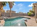 Refreshing backyard pool, complete with privacy fence and mature palm trees at 16585 W Tonto St, Goodyear, AZ 85338