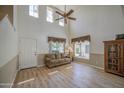 Bright living room with a high ceiling, wood floors and large windows at 1720 W Orchid Ln, Chandler, AZ 85224