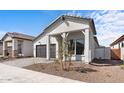 Exterior view showcasing the modern farmhouse design, landscaping, and paver driveway at 20308 W Montecito Ave, Buckeye, AZ 85396