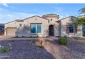 Single-story home with beige stucco exterior and a charming courtyard entryway at 21325 S 201St Way, Queen Creek, AZ 85142