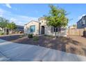 Single-story stucco home showcasing low maintenance desert landscaping at 21325 S 201St Way, Queen Creek, AZ 85142