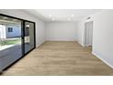 Spacious living room with wood-look flooring, recessed lighting, and sliding glass doors leading to the patio at 2201 W Avalon Dr, Phoenix, AZ 85015