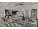 Expansive living room with coffered ceilings seamlessly connects to the kitchen for open-concept living at 2522 E Presidio St, Mesa, AZ 85213