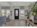 Bright, neutral living area features wood-look tile flooring and black trimmed windows for modern appeal at 2522 E Presidio St, Mesa, AZ 85213