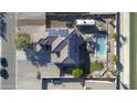 Aerial view of a home with solar panels, a swimming pool, a hot tub, and manicured landscaping at 31918 N Caspian Way, San Tan Valley, AZ 85143