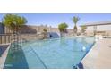 Backyard swimming pool featuring waterfall feature, desert landscaping, and ample space for outdoor seating at 31918 N Caspian Way, San Tan Valley, AZ 85143