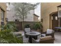 Relaxing backyard seating around a fire pit with lush, mature landscaping at 3911 E Rockingham Rd, Phoenix, AZ 85050