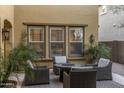 Cozy outdoor patio seating with cushioned chairs and a round fire pit table at 3911 E Rockingham Rd, Phoenix, AZ 85050