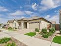 Inviting single-Gathering home with a two-car garage, covered entryway, and desert-style landscaping at 4164 E Bernice St, Gilbert, AZ 85295