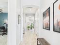 Bright and airy hallway with neutral walls, tile floors, and decorative accents leading to other rooms at 4164 E Bernice St, Gilbert, AZ 85295
