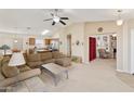 Spacious living room with carpeted floors, ceiling fan, and open layout at 42370 W Hillman Dr, Maricopa, AZ 85138