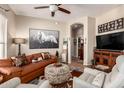 Inviting living room features hardwood floors, a ceiling fan, and comfortable leather seating at 42424 N Gavilan Peak Pkwy # 63212, Anthem, AZ 85086