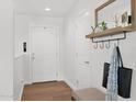 Bright entryway featuring wood floors, white walls, and a coat rack with mirror for added convenience at 4739 N 34Th Pl, Phoenix, AZ 85018