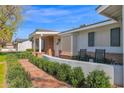 Inviting front porch with brick pathway, trimmed shrubs, and a cozy seating area at 4739 N 34Th Pl, Phoenix, AZ 85018