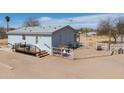 Aerial of house showing deck, white fence and desert landscaping, with blue sky above at 49853 W Jean Dr, Maricopa, AZ 85139