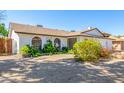 Single-story home featuring desert landscaping, white brick, and a convenient two-car garage at 5325 W Desert Hills Dr, Glendale, AZ 85304