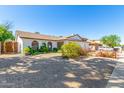 Single-story home featuring desert landscaping, white brick, and a convenient two-car garage at 5325 W Desert Hills Dr, Glendale, AZ 85304
