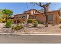 Charming single-Gathering home with a well-manicured front yard and gravel landscaping at 7600 E Golden Eagle Cir, Gold Canyon, AZ 85118