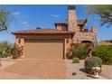 Spacious two-car garage with an attractive driveway and lush landscaping at 7600 E Golden Eagle Cir, Gold Canyon, AZ 85118