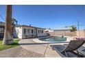 Backyard features a sparkling private pool surrounded by well-kept landscaping, seating and a patio at 8408 E Lewis Ave, Scottsdale, AZ 85257
