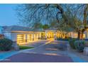 Beautiful home exterior featuring well-maintained landscaping and illuminated garage doors at 9041 N 46Th St, Phoenix, AZ 85028