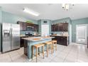 Bright kitchen showcasing an island with seating, stainless steel appliances, and stylish countertops at 4053 N 308Th Ln, Buckeye, AZ 85396