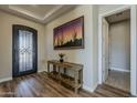Inviting foyer with wood floors, console table, and decorative sunset artwork at 459 E Bracciano Ave, Queen Creek, AZ 85140