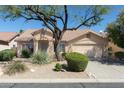Charming single-story home featuring a well-maintained desert landscape and a two-car garage at 10316 E Rimrock Loop, Gold Canyon, AZ 85118