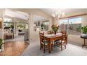 Dining area featuring a rustic wood table, carpet flooring, and plenty of natural light at 10804 W Mohawk Ln, Peoria, AZ 85373