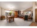 Bright living room featuring carpet floors and large windows offering a pleasant view at 10804 W Mohawk Ln, Peoria, AZ 85373
