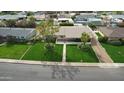Aerial view of a well-manicured single-story home with a large front yard and mature trees at 2017 W Edgemont Ave, Phoenix, AZ 85009