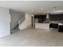 Open-concept living space features stairs, recessed lighting, and flows into a modern kitchen at 2470 W Rowel Rd, Phoenix, AZ 85085