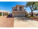 Charming two-story home featuring a neutral stucco exterior, tile roof, and a spacious two-car garage at 13711 N 81St Ave, Peoria, AZ 85381