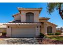 Charming two-story home featuring a neutral stucco exterior, tile roof, and a spacious two-car garage at 13711 N 81St Ave, Peoria, AZ 85381