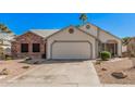 Charming single-Gathering home with desert landscaping and a two-car garage on a clear day at 1449 E Kent Ave, Chandler, AZ 85225