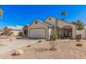 Charming single-Gathering home with desert landscaping and a two-car garage on a clear day at 1449 E Kent Ave, Chandler, AZ 85225