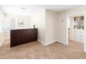 Reception area with tile flooring, featuring a dark wood reception desk and neutral walls at 1624 W Thomas Rd, Phoenix, AZ 85015