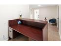 Close up of reception desk with drawers and storage; neutral walls and tile flooring at 1624 W Thomas Rd, Phoenix, AZ 85015